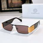 Versace sunglasses with black frames and mauve tinted lenses, gold temple emblem