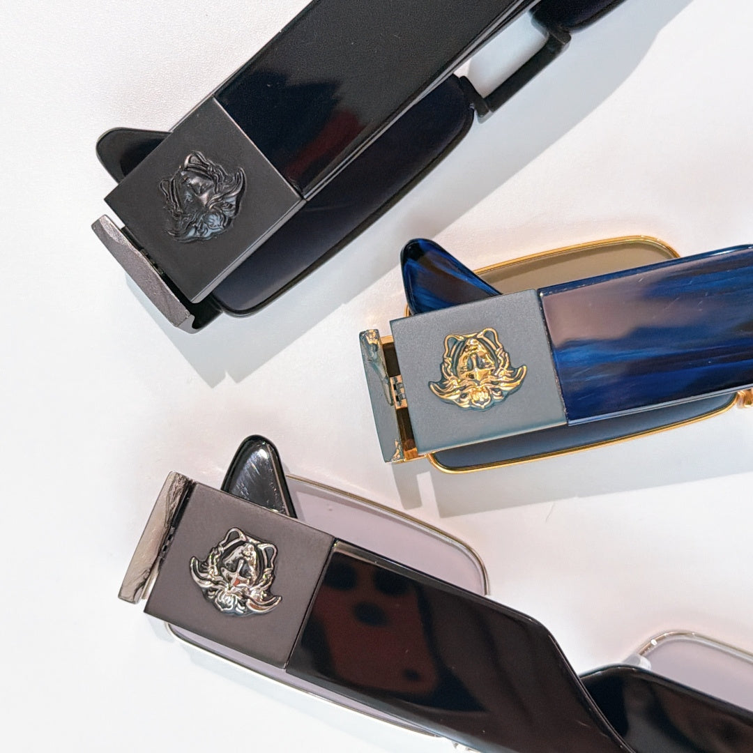 Versace sunglasses showing temple emblems and lens colors in a flat lay