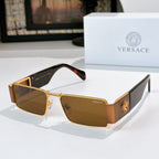 Versace sunglasses with gold frames and amber tinted lenses, lion emblem on temple