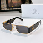 Versace sunglasses with gold frames and dark tinted lenses, black temple accents
