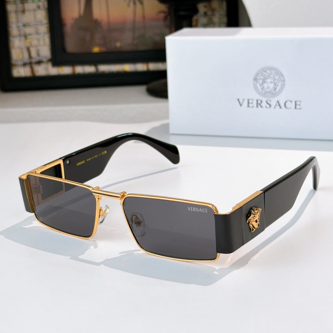 Versace sunglasses with gold frames and dark tinted lenses, black temple accents