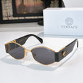 Cat-eye sunglasses with gold-tone frame, dark lenses, and black temples with logo detail.