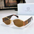 Cat-eye sunglasses with gold-tone frame, amber lenses, and tortoise-look temples with logo detail.