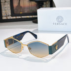 Cat-eye sunglasses with gold-tone frame, dark lenses, and blue temples with logo detail.