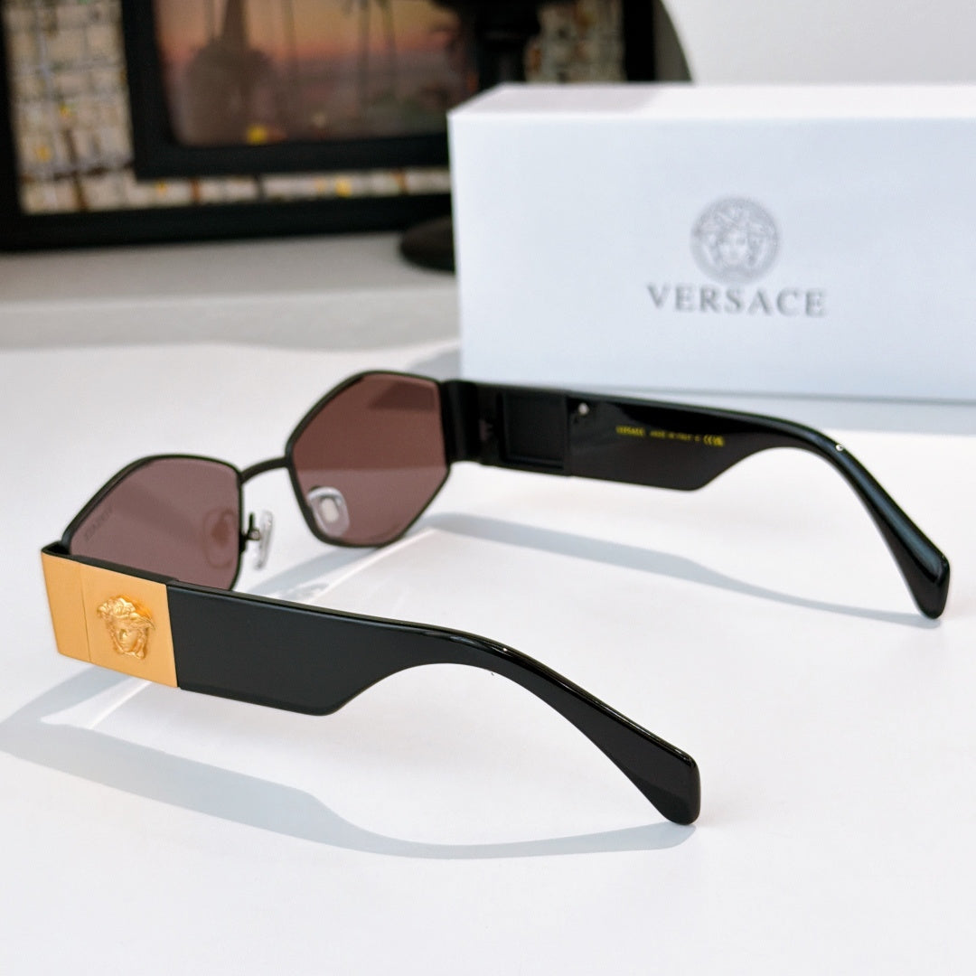 Cat-eye sunglasses side view with black frame, gold accents, and rose-brown lenses.
