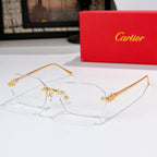 Gold eyeglasses with clear lenses and ornate metal bridge and temple accents.