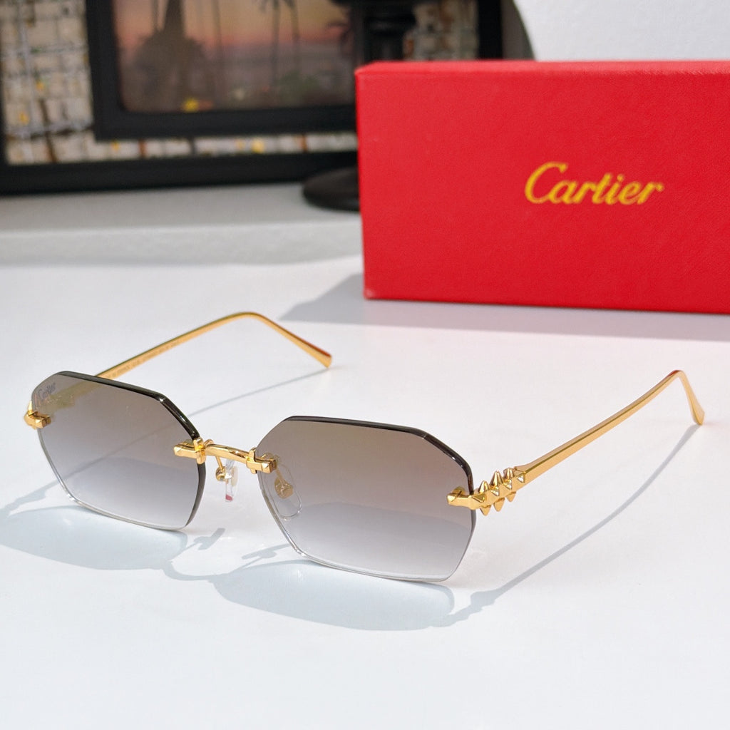 Gold cat-eye sunglasses with dark tinted lenses and decorative temple engraving.