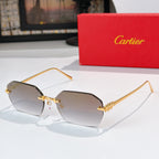 Gold cat-eye sunglasses with dark tinted lenses and decorative temple engraving.