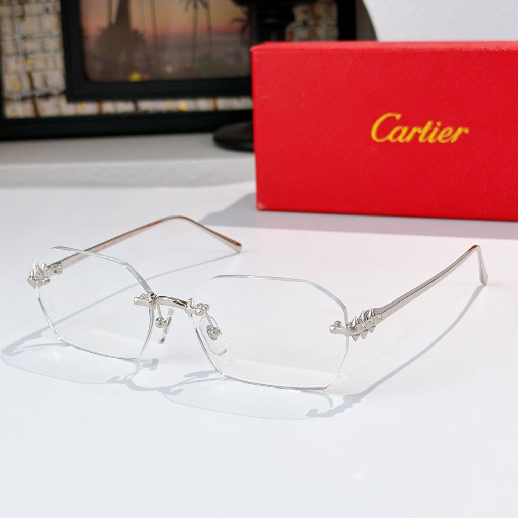 Silver eyeglasses with clear lenses and ornate metal bridge and temple accents.