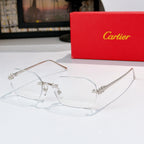 Silver eyeglasses with clear lenses and ornate metal bridge and temple accents.