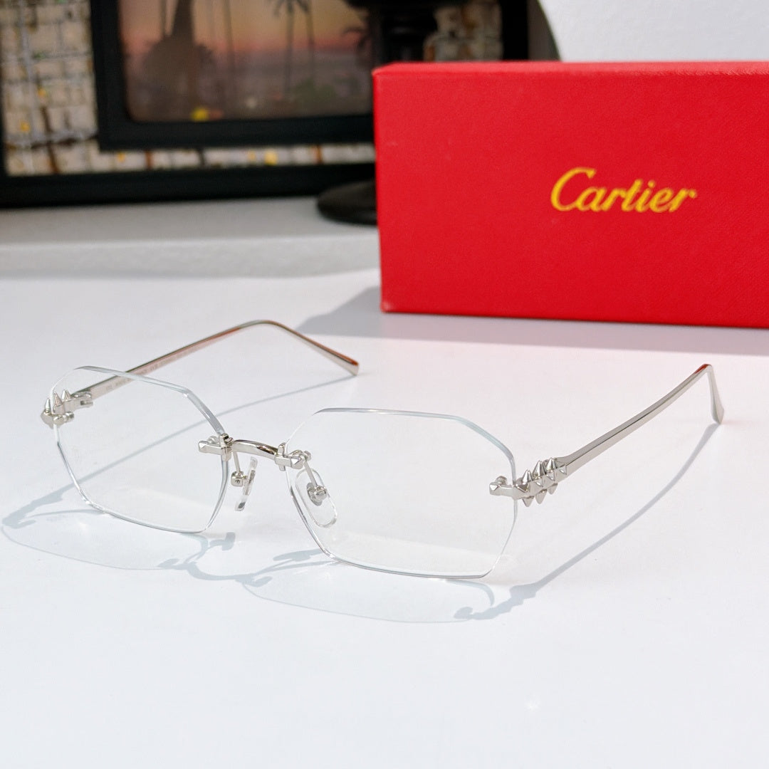 Silver eyeglasses with clear lenses and ornate metal bridge and temple accents.