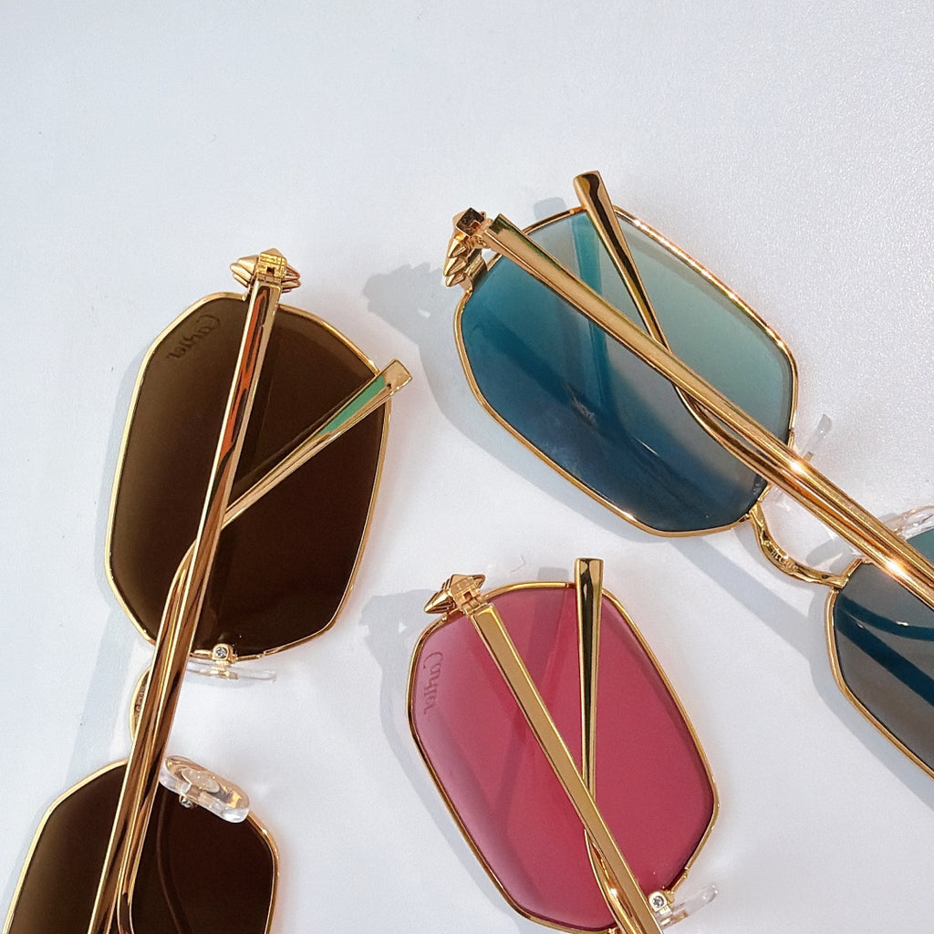 Gold-tone sunglasses assortment with blue, pink, and brown tinted lenses