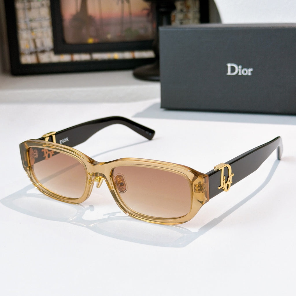 Dior sunglasses with gold frames and light brown gradient lenses