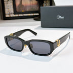 Dior sunglasses with black frames and dark lenses with gold accents