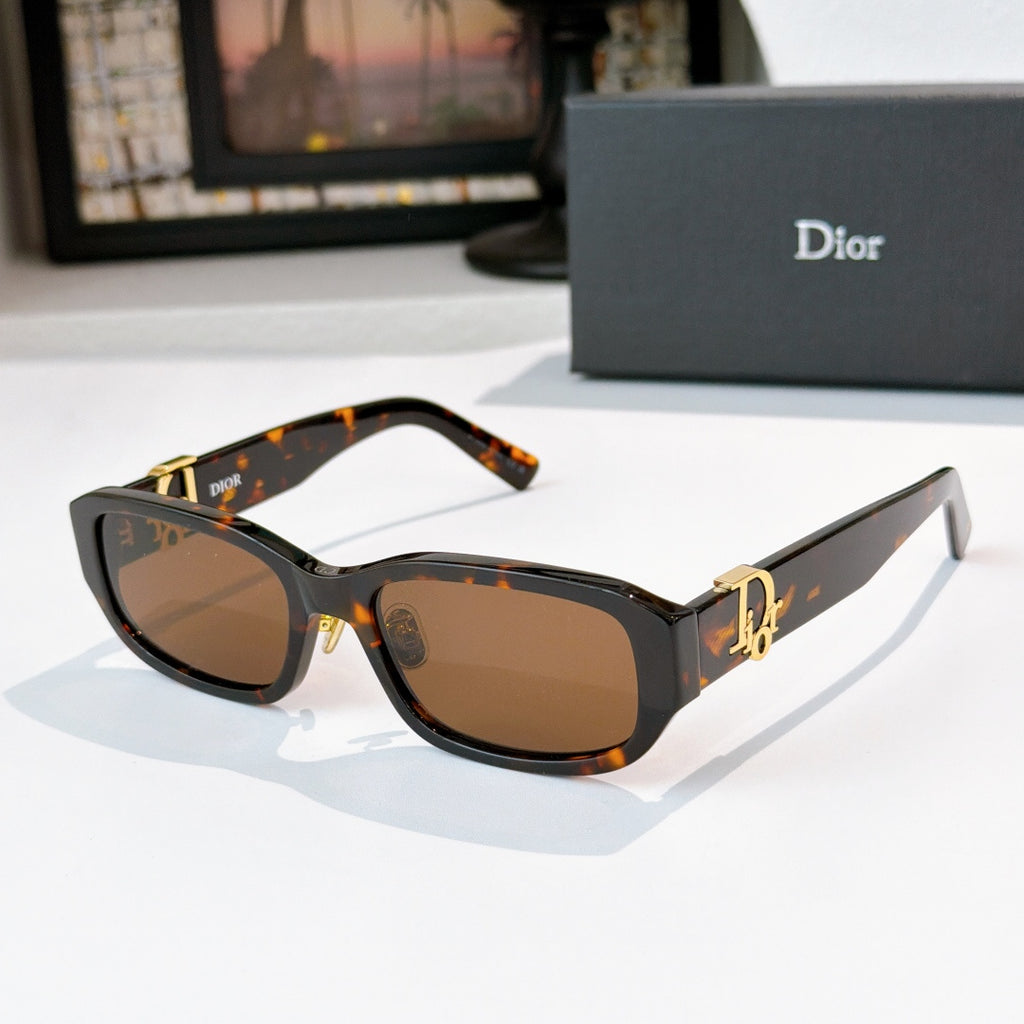 Dior sunglasses with dark tortoiseshell frames and brown gradient lenses