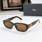 Dior sunglasses with dark tortoiseshell frames and brown gradient lenses