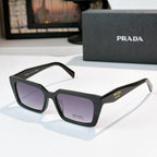 Black square sunglasses with dark lenses and Prada logo on temples
