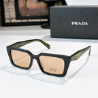 Black square sunglasses with tan lenses and green-accent temple, Prada logo