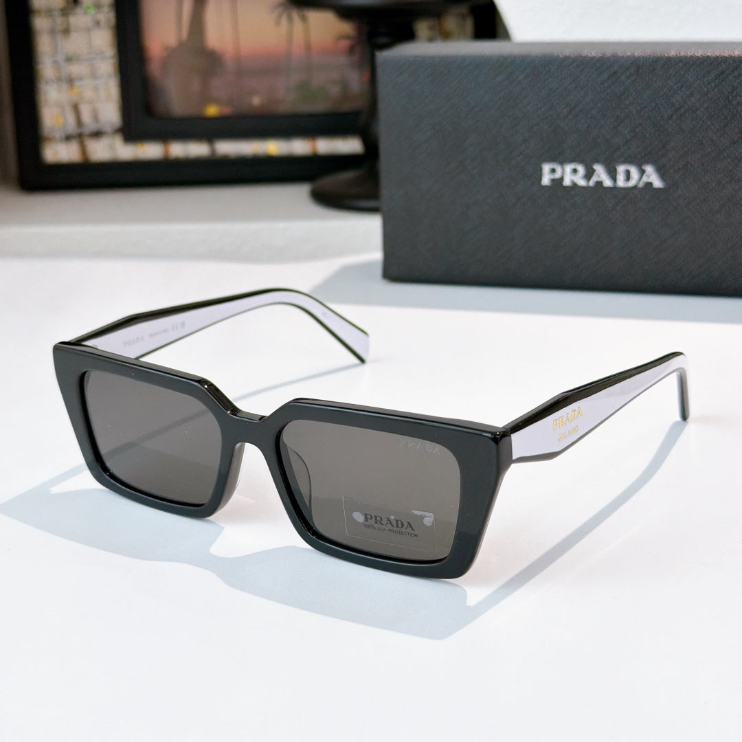 Dark gray square sunglasses with gray lenses and Prada logo on front and temple