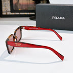 Red-accent square sunglasses with brown lenses and Prada logo on temple