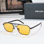 Prada sunglasses with yellow lenses and brown frame, cat-eye silhouette