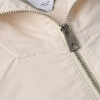 Off-white hooded jacket with silver zipper and zip pull close-up