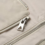 Off-white jacket with silver zipper and metal logo pull detail
