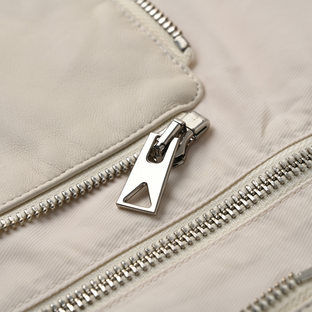 Off-white jacket with silver zipper and metal logo pull detail