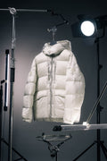 White hooded Moncler puffer jacket with full-zip front and front patch