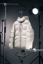 White hooded Moncler puffer jacket with full-zip front and front patch