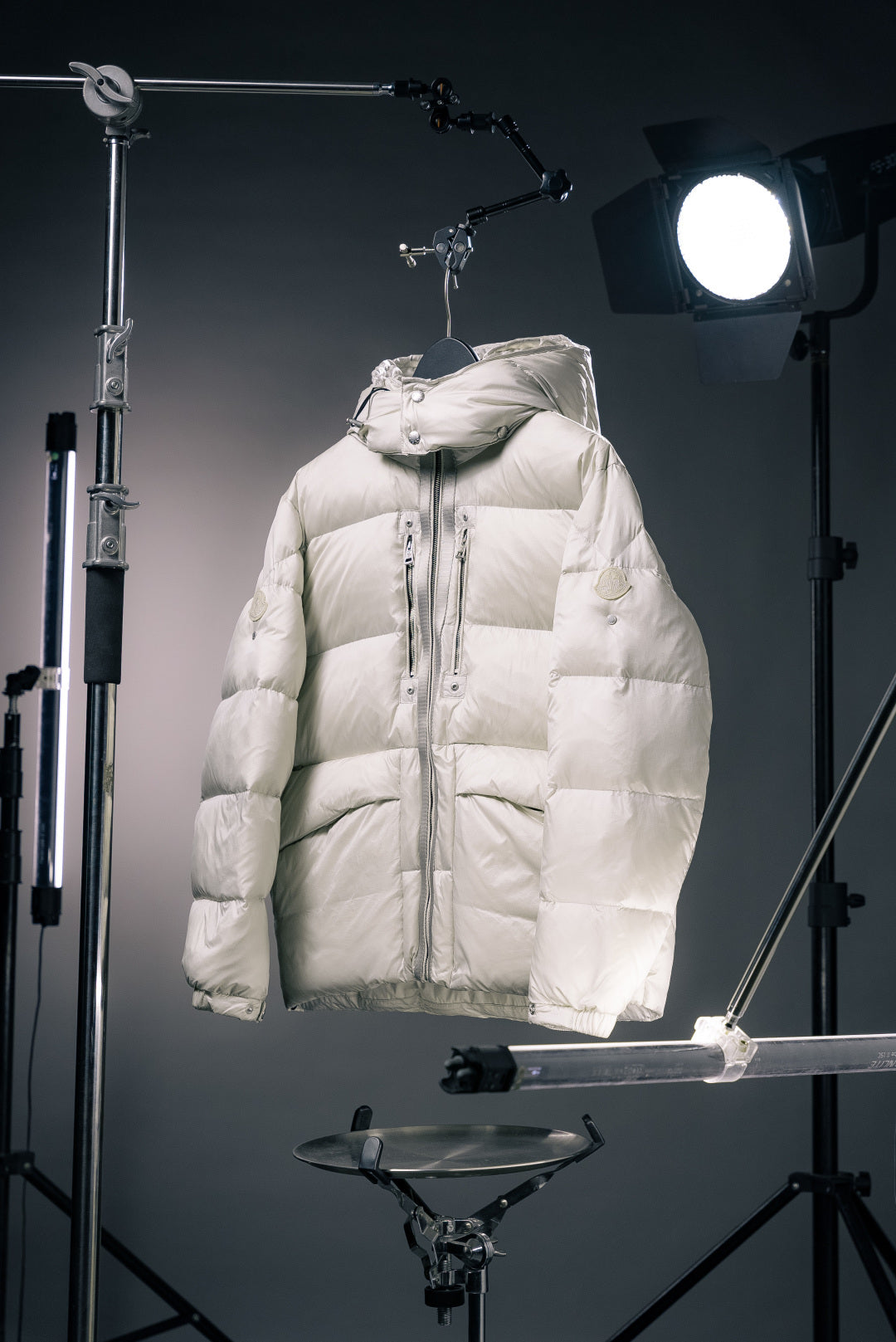 White hooded Moncler puffer jacket with full-zip front and front patch