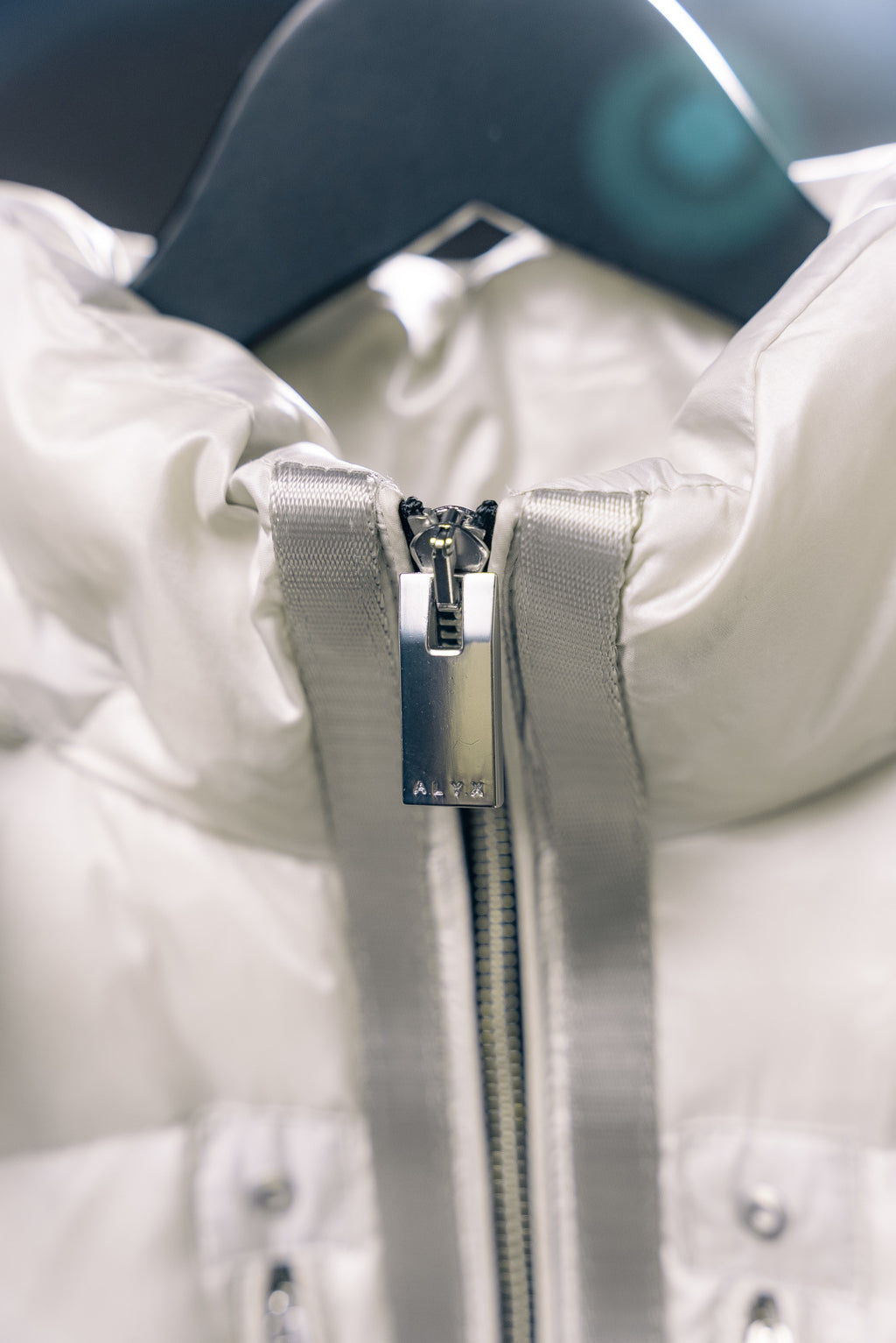 White Moncler puffer jacket front zipper with hood pull tab