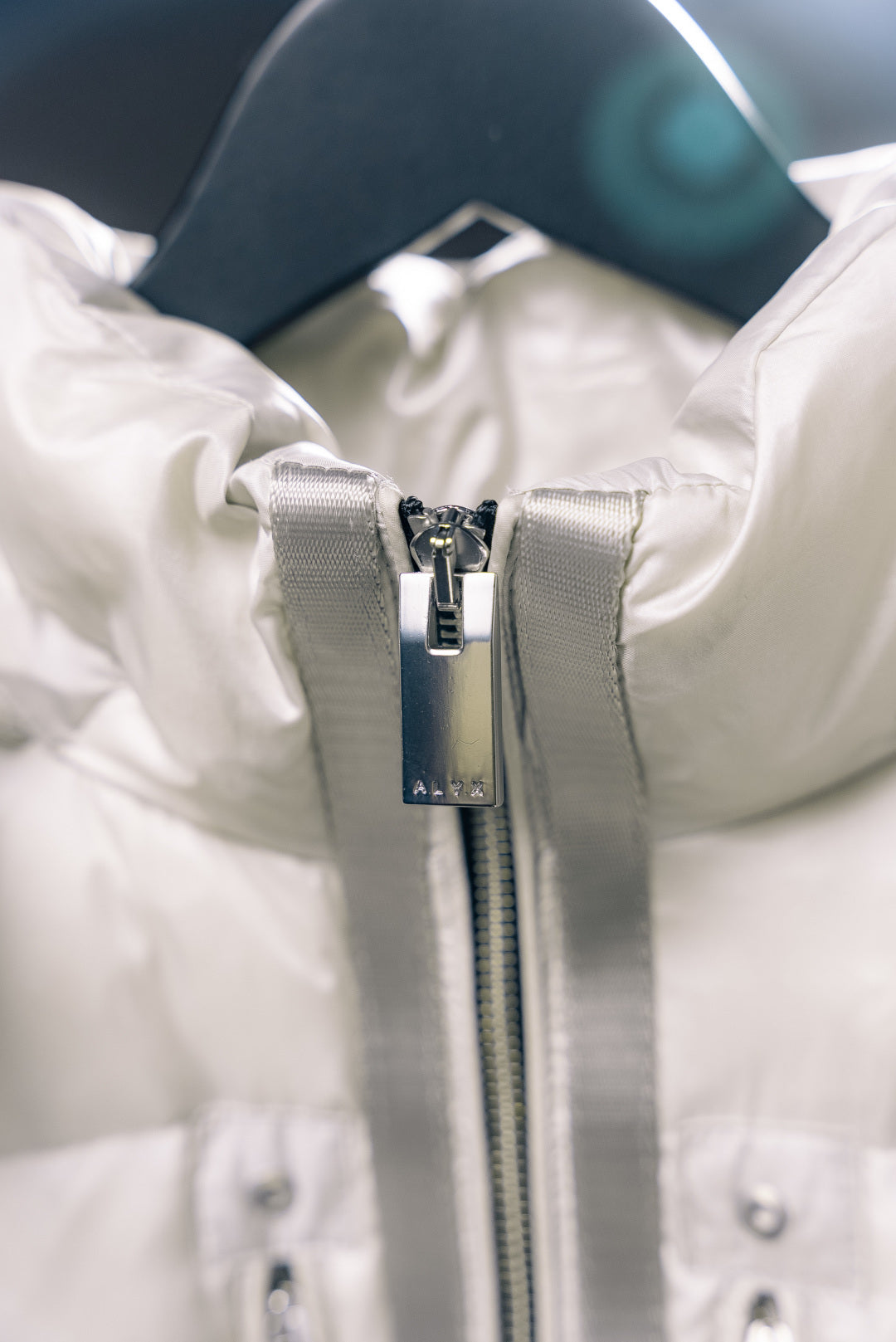 White Moncler puffer jacket front zipper with hood pull tab