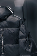 Moncler puffer jacket shoulder and sleeve detail with snap buttons, dark fabric