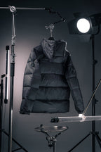 Long Moncler puffer jacket with hood, padded quilted panels, dark fabric
