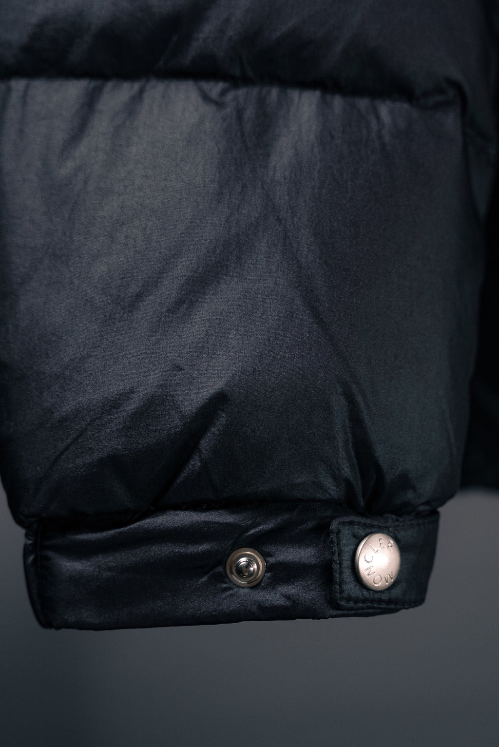 Moncler puffer jacket lower hem with snap button and ribbed cuff