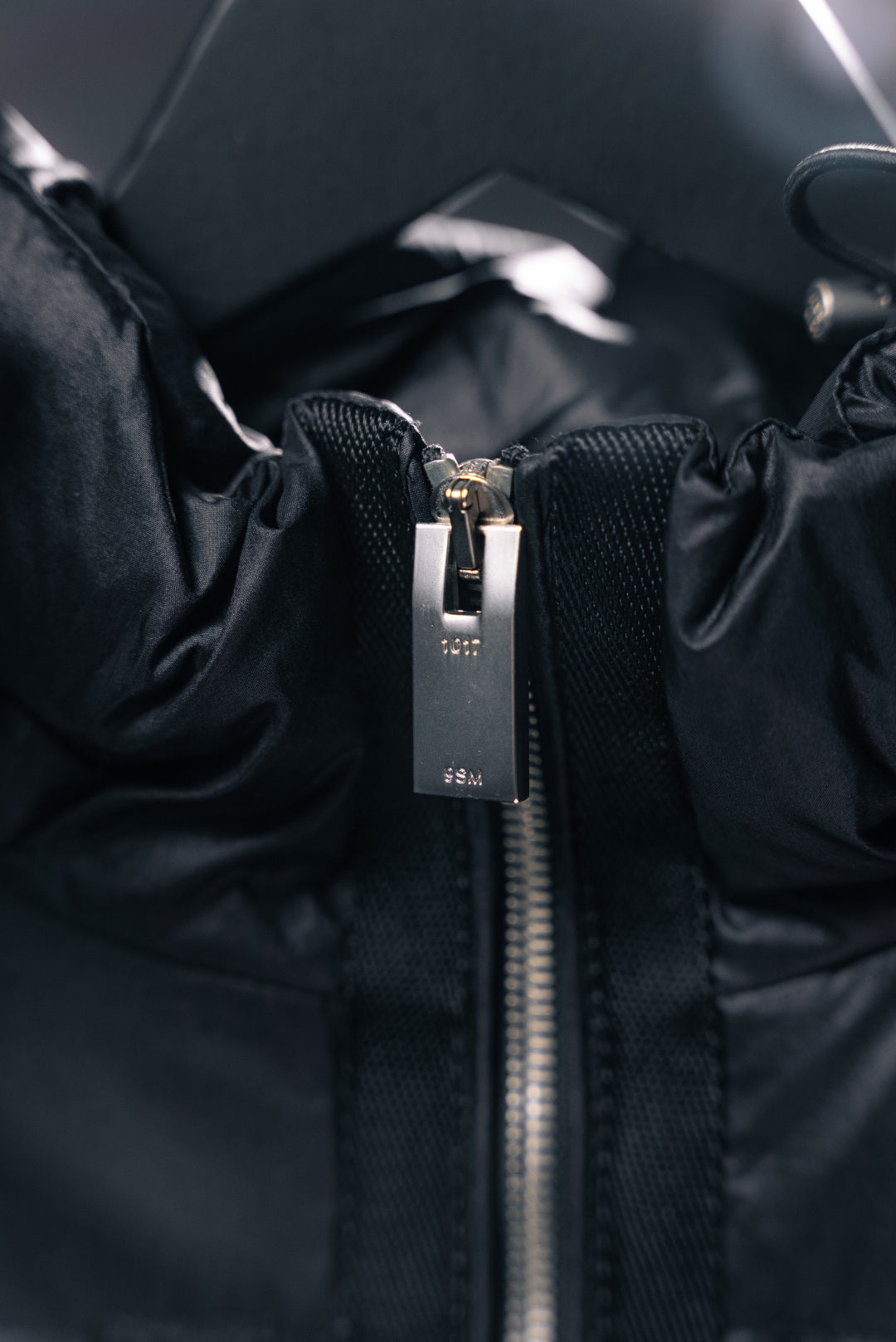 Moncler puffer jacket front zipper with metal pull, dark fabric