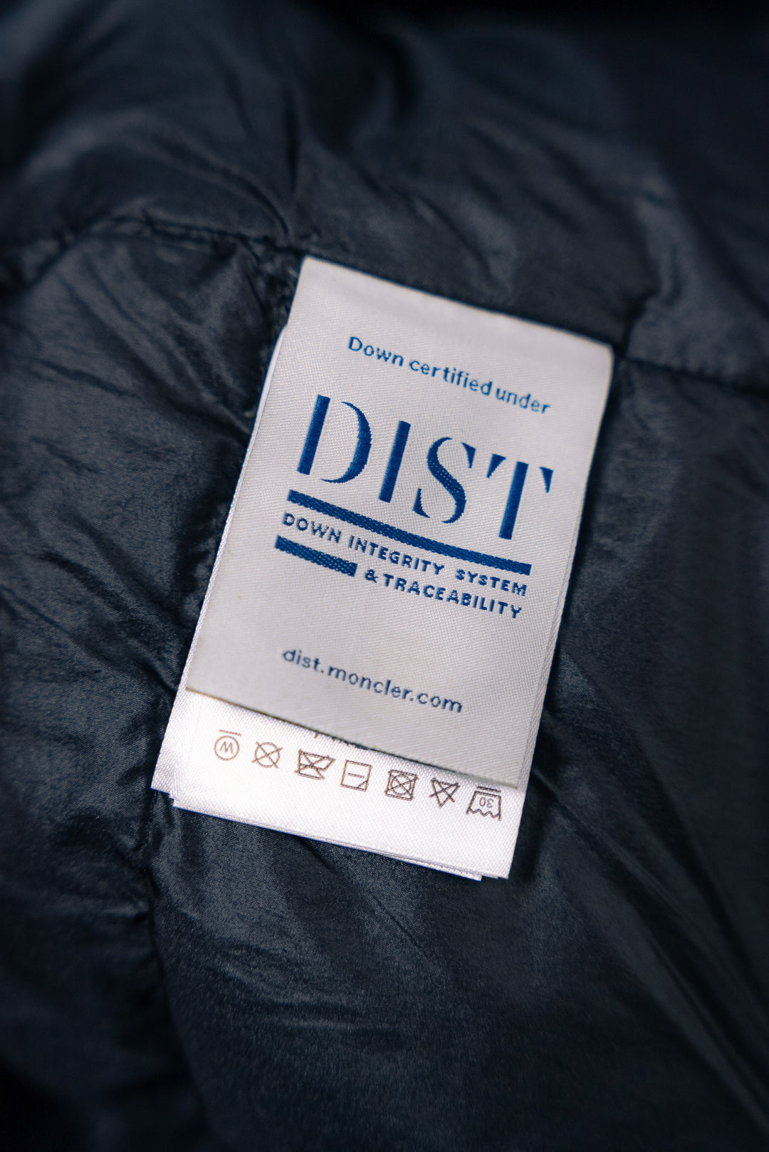 Puffer jacket label: Down certified under DIST system, traceability info