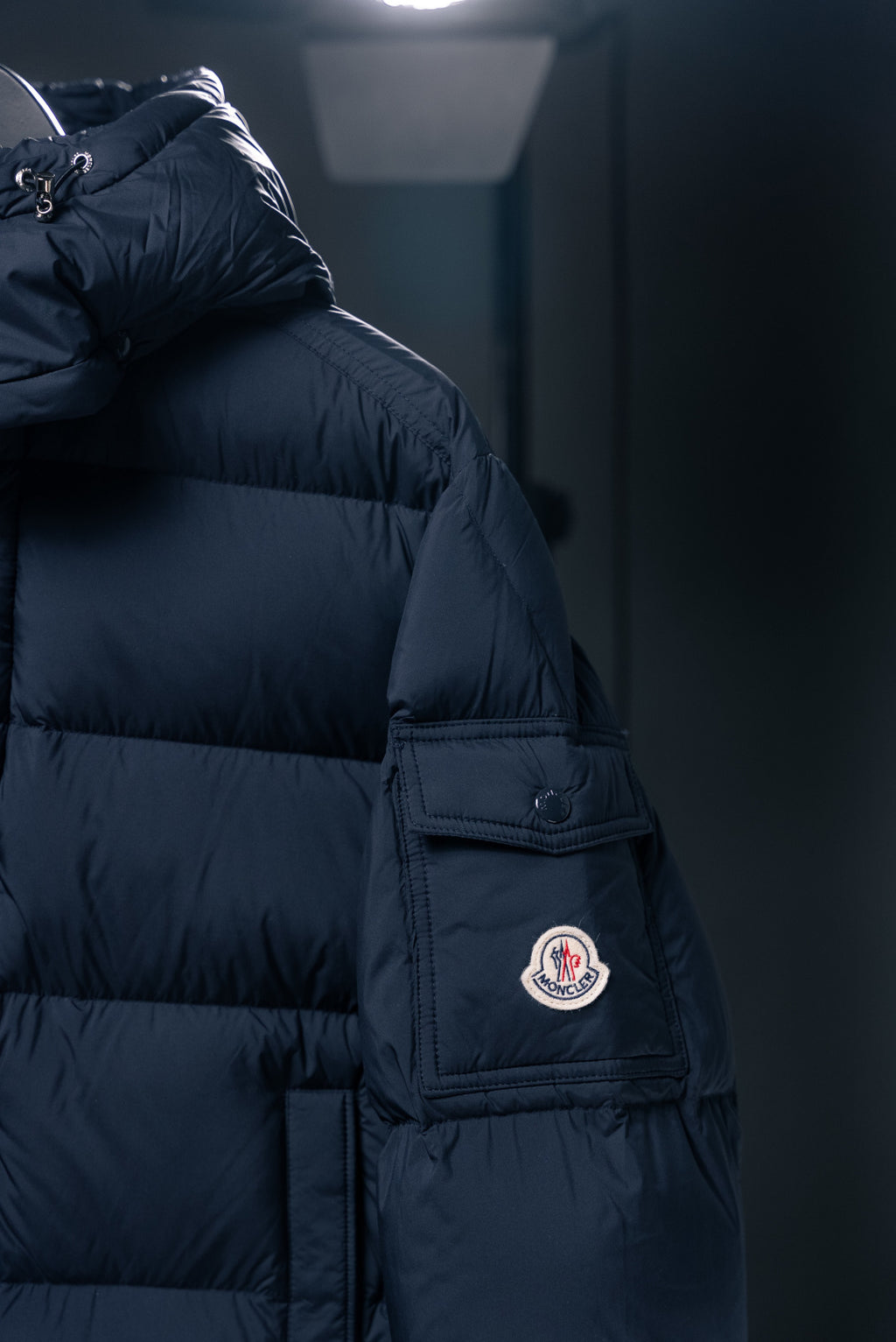 Moncler long puffer jacket shoulder with logo patch and zipper pocket panel