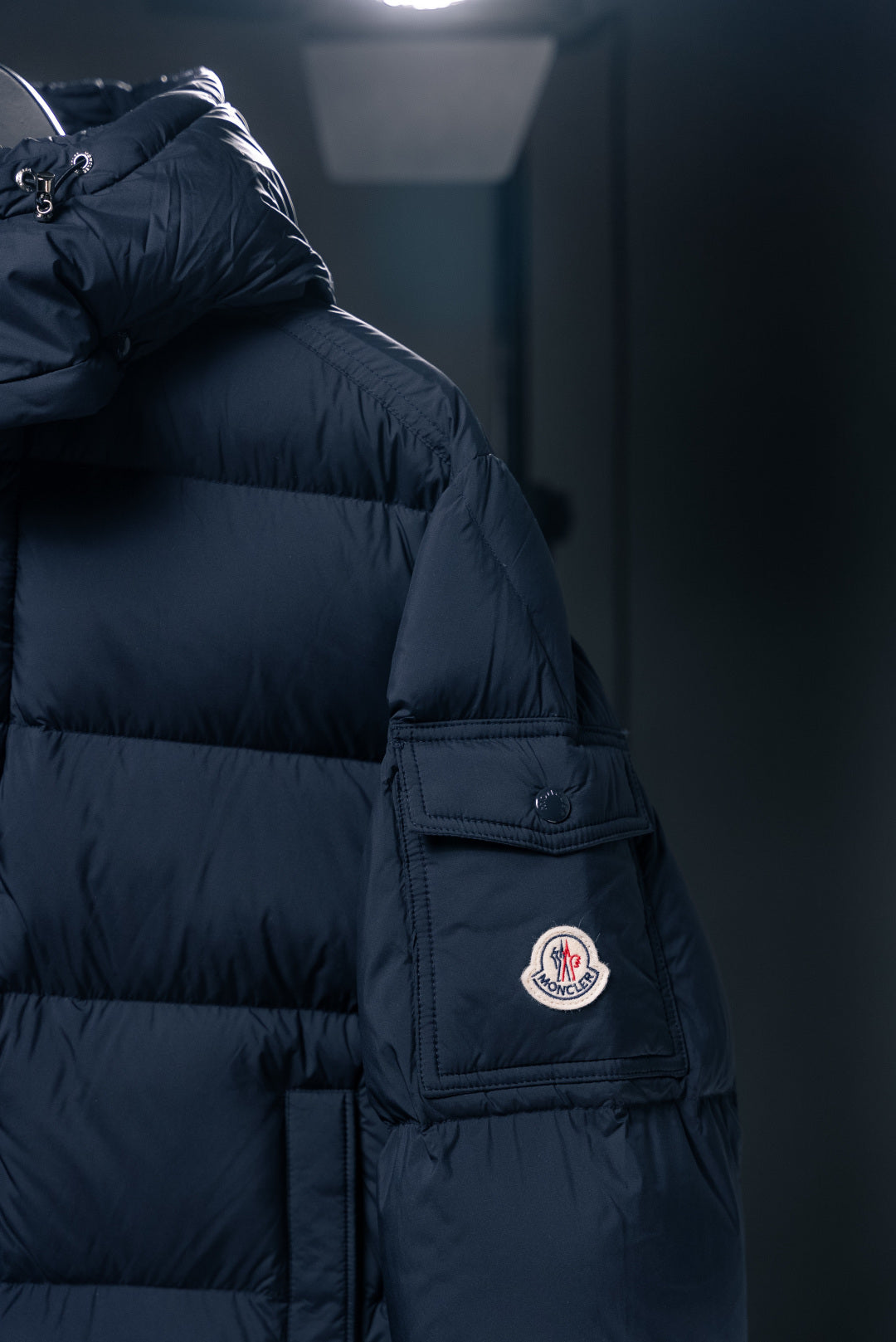 Moncler long puffer jacket shoulder with logo patch and zipper pocket panel