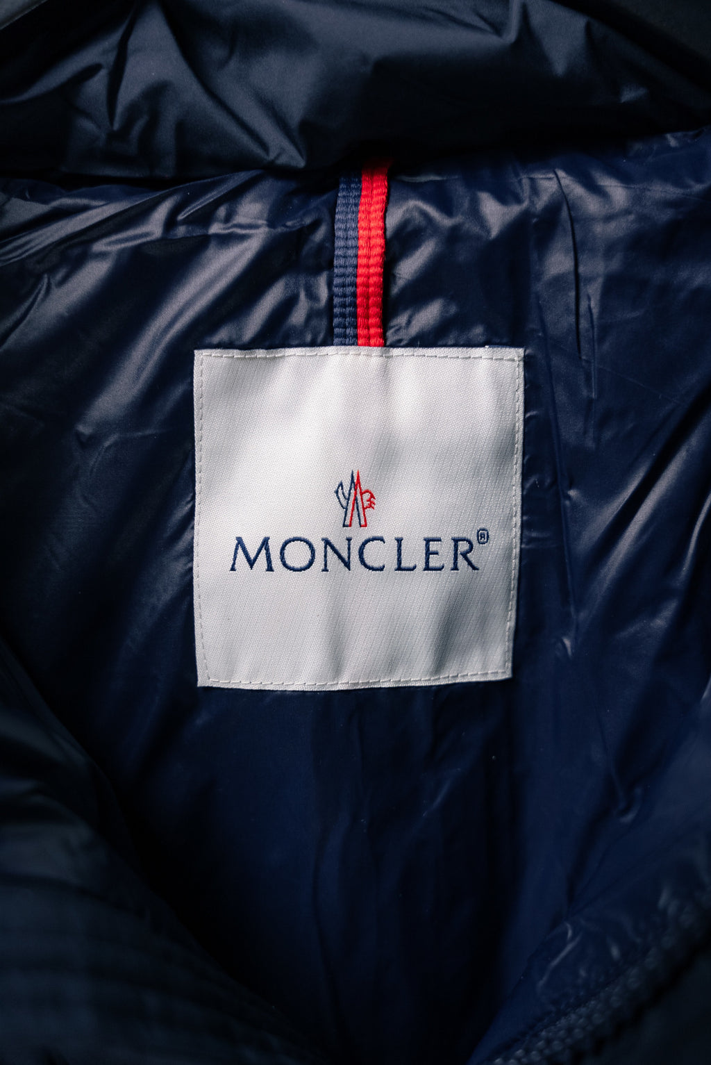 Moncler jacket interior label with red stripe trim