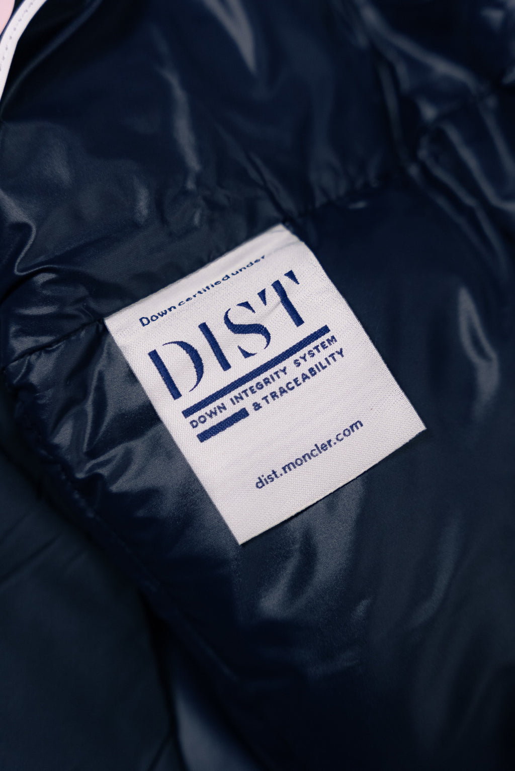 Moncler jacket interior care label with blue 'DIST' text