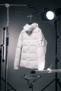 White hooded long puffer jacket with front zip and quilted panels