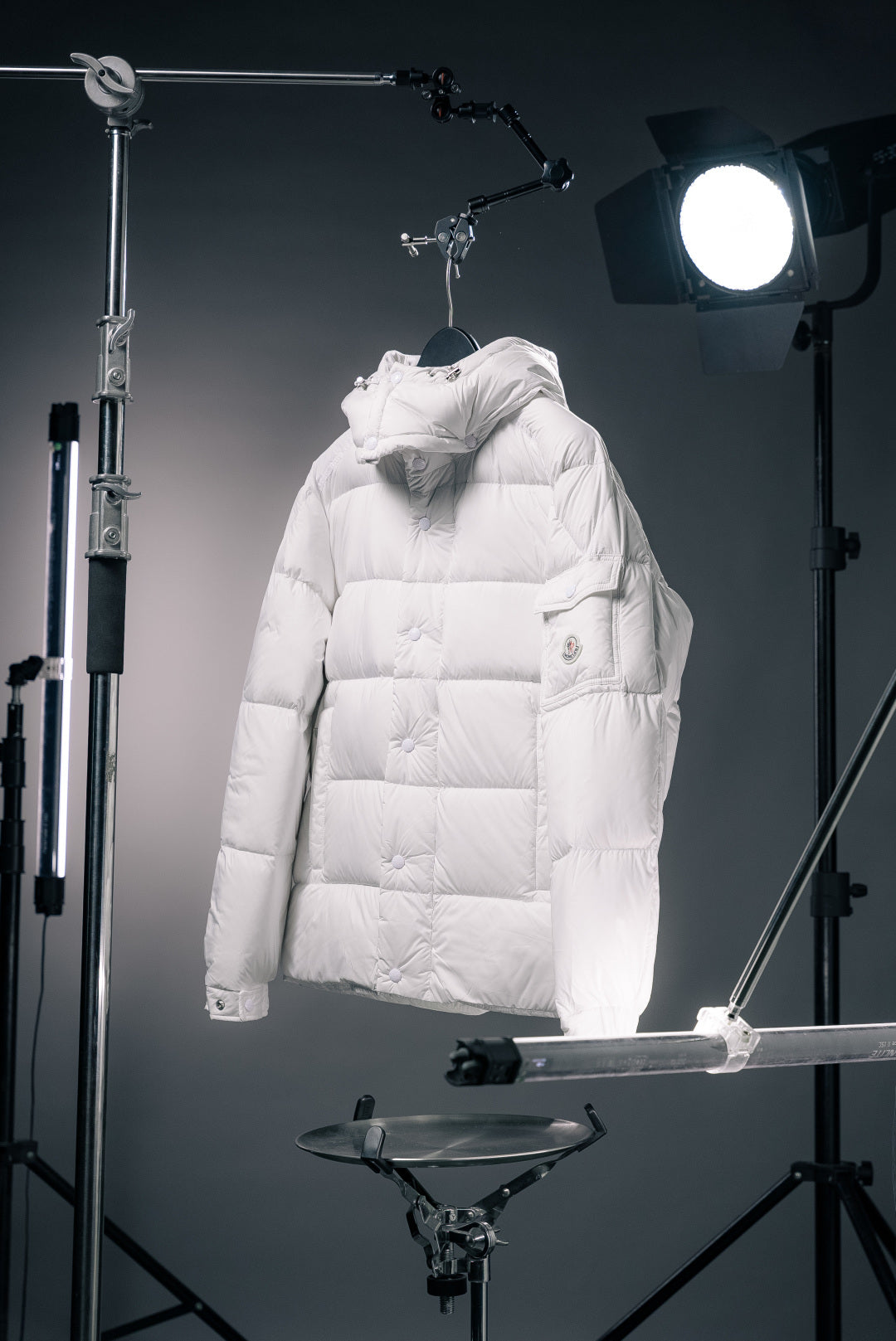 White hooded long puffer jacket with front zip and quilted panels