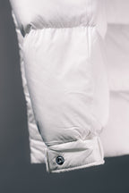 White puffer jacket lower hem with buttoned pocket flap