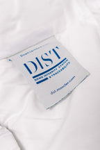 White puffer jacket certification label with text and “dist.moncler.com”