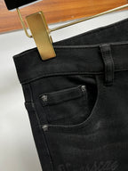 Black denim jeans with contrast pocket stitching and small Versace logo badge
