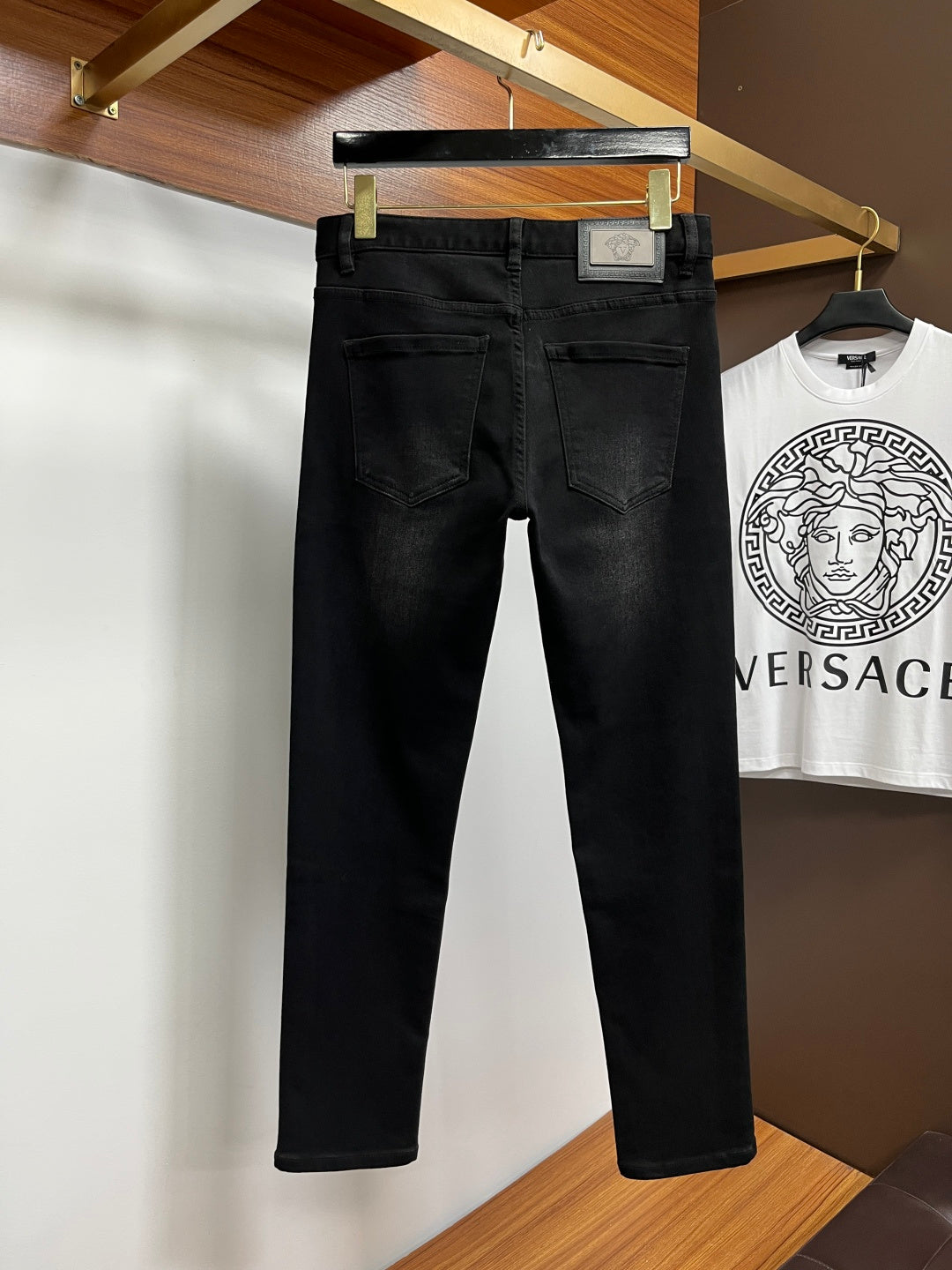 Black Versace jeans front view with belt loops and stitched pockets