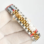 Two-tone wristwatch with gold-accented bracelet links and case side
