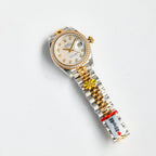Two-tone wristwatch with white dial, diamond bezel, and gold-and-steel bracelet